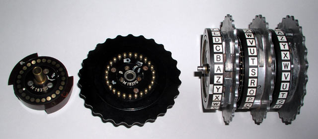 Picture of a reflector, a rotor on its side, and three rotors on their shaft.