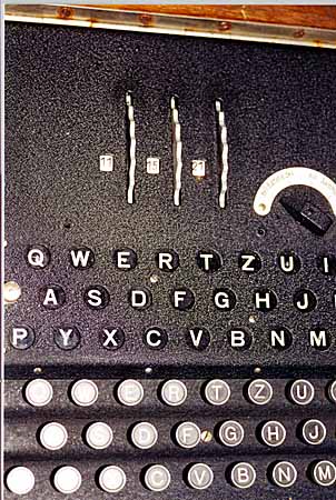Top view of an enigma machine, showing from top to bottom a display for the rotors positions, the lampboard, and a keyboard